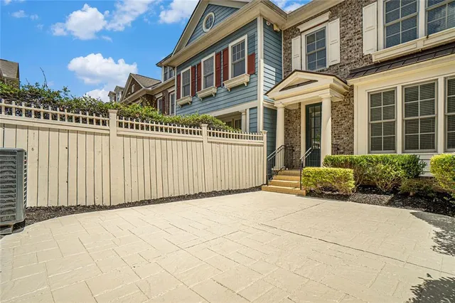 a view of a brick building next to a yard
