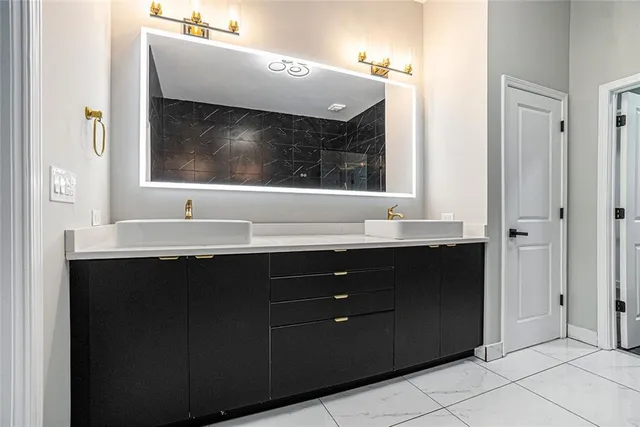 a bathroom with a sink vanity and mirror