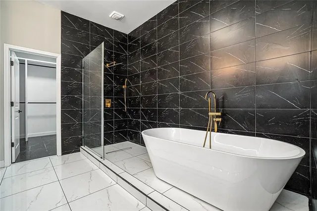 a bathroom with a bathtub and a shower