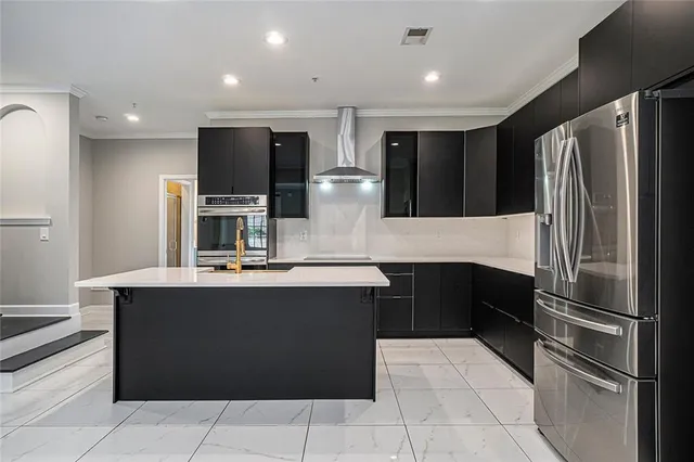 a kitchen with stainless steel appliances granite countertop a refrigerator and a stove