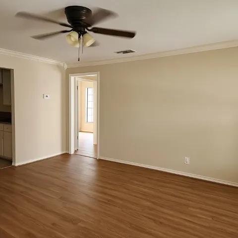 a view of an empty room and wooden floor