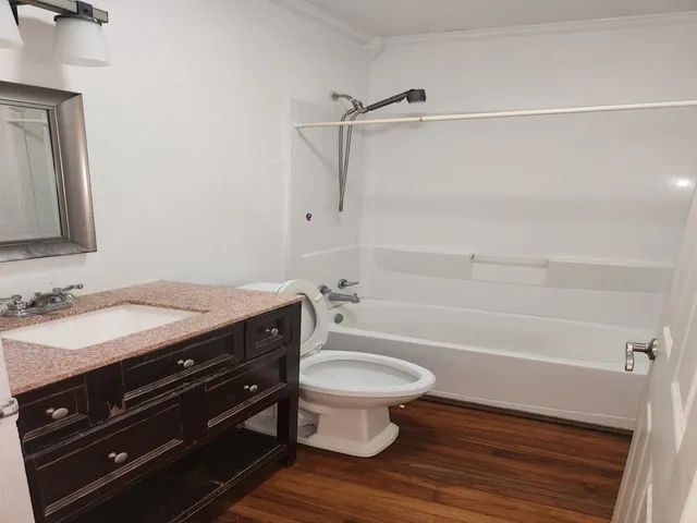 a bathroom with a sink a toilet and a bathtub