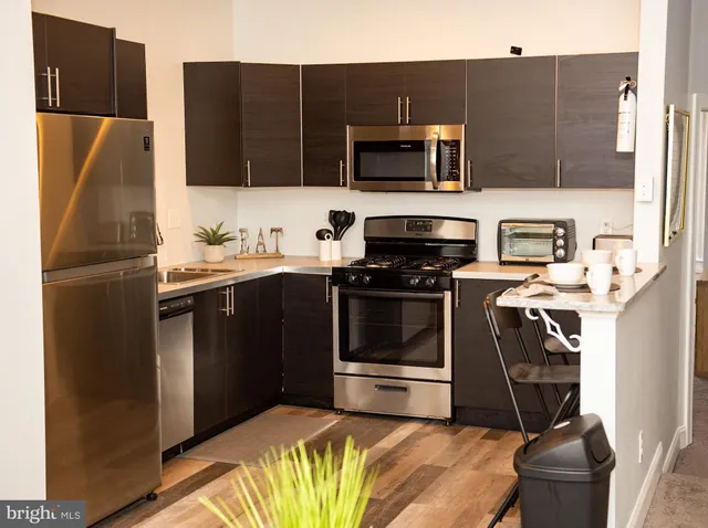 a kitchen with a sink and steel appliances