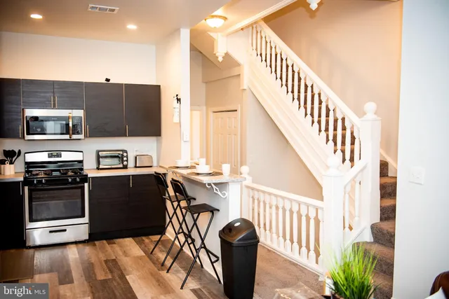 a view of kitchen with sink microwave and stove