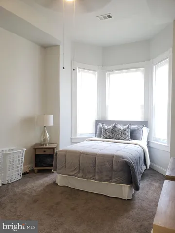 a bedroom with a bed and window