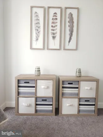 a room with a flat screen tv and white walls