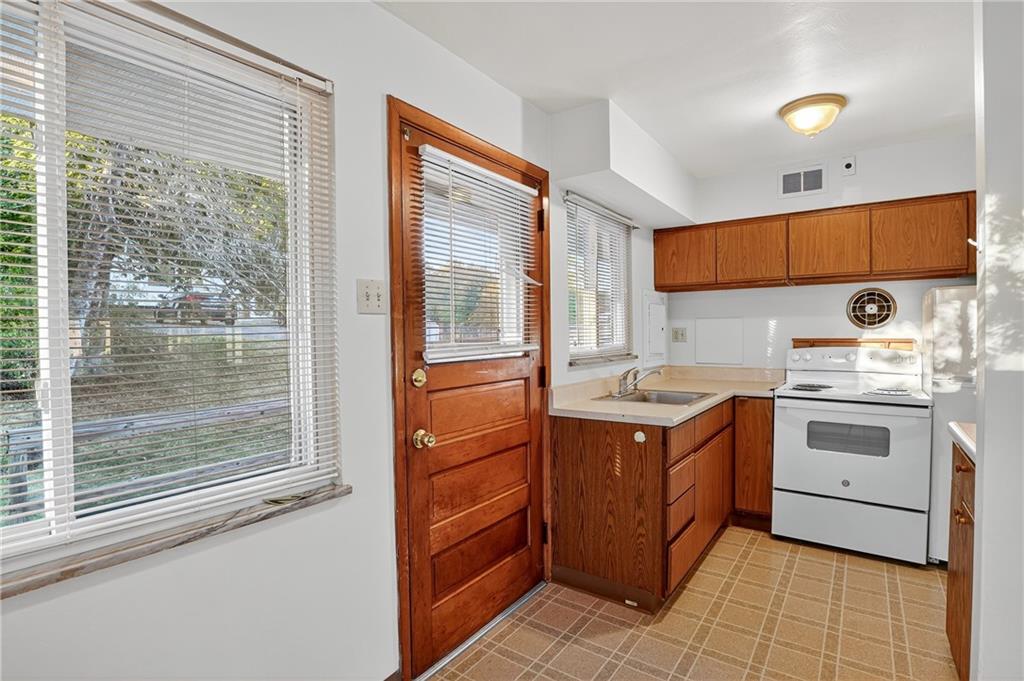 718 West Ingomar Road Pittsburgh, PA 15237 - Photo 11 of 40 a kitchen with a stove sink and cabinets