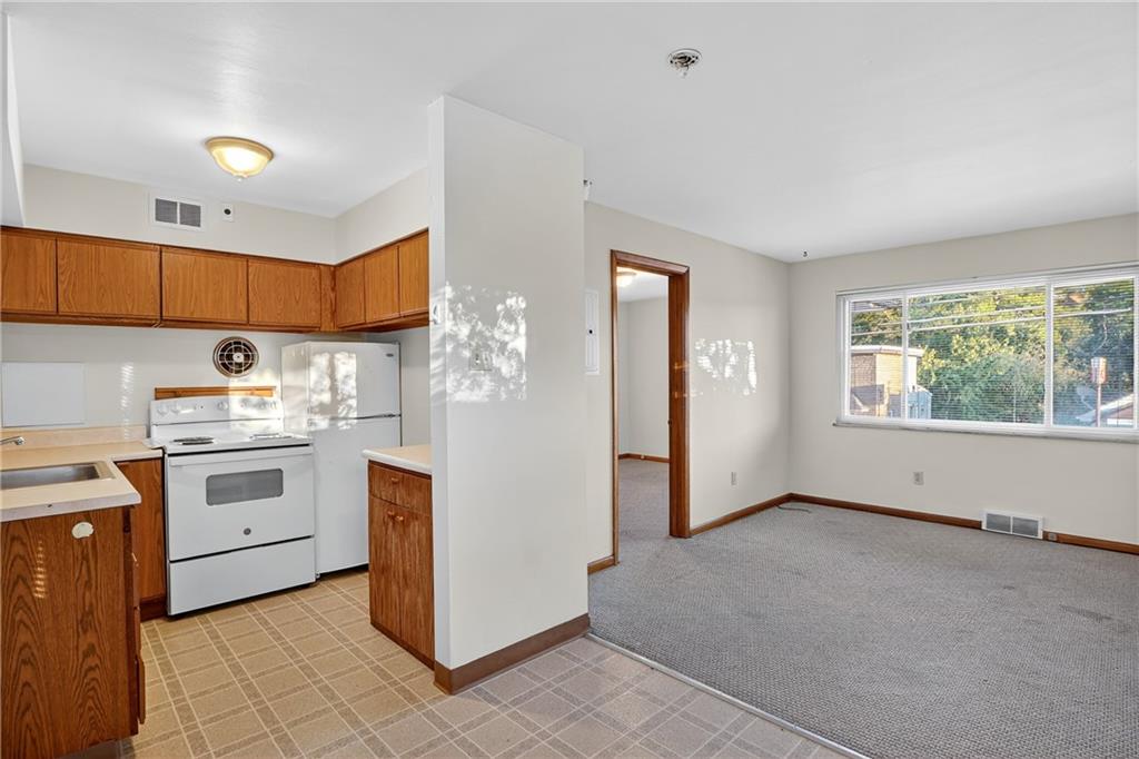 718 West Ingomar Road Pittsburgh, PA 15237 - Photo 12 of 40 a kitchen with white cabinets and white appliances