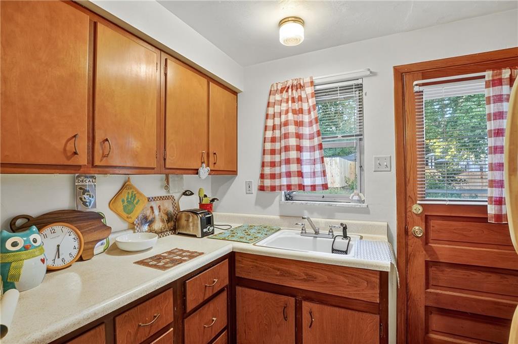 718 West Ingomar Road Pittsburgh, PA 15237 - Photo 22 of 40 a kitchen with stainless steel appliances granite countertop a sink a stove and a wooden cabinets