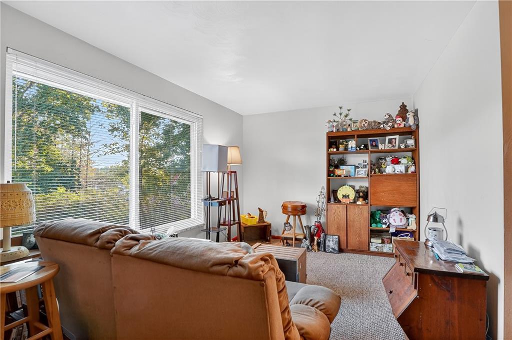 718 West Ingomar Road Pittsburgh, PA 15237 - Photo 26 of 40 a living room with furniture a floor to ceiling window and a flat screen tv