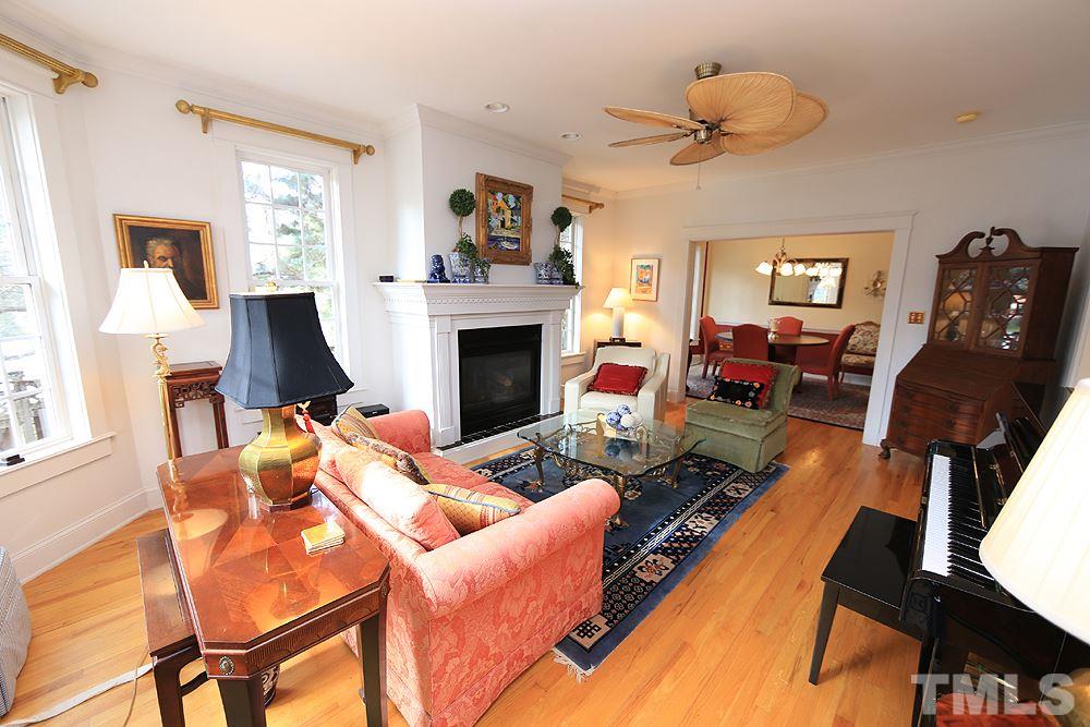 1802 Reaves Drive Raleigh, NC 27608 - Photo 2 of 22 a living room with furniture a fireplace and a flat screen tv