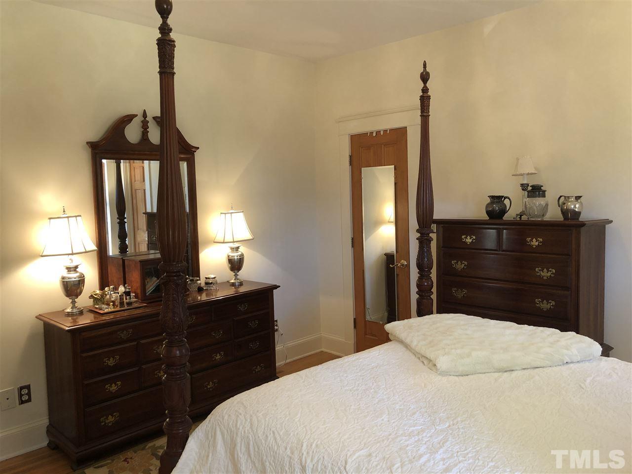 1802 Reaves Drive Raleigh, NC 27608 - Photo 11 of 22 a bedroom with a bed and a dresser