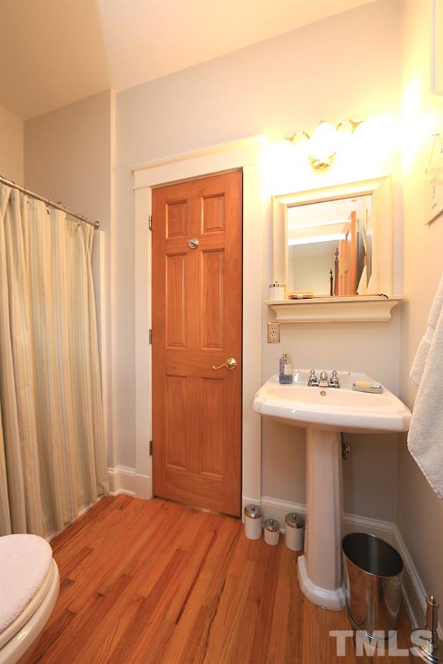 1802 Reaves Drive Raleigh, NC 27608 - Photo 12 of 22 a bedroom with a sink and a mirror
