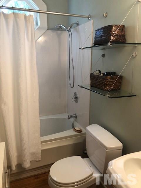 1802 Reaves Drive Raleigh, NC 27608 - Photo 15 of 22 a bathroom with a toilet and a shower