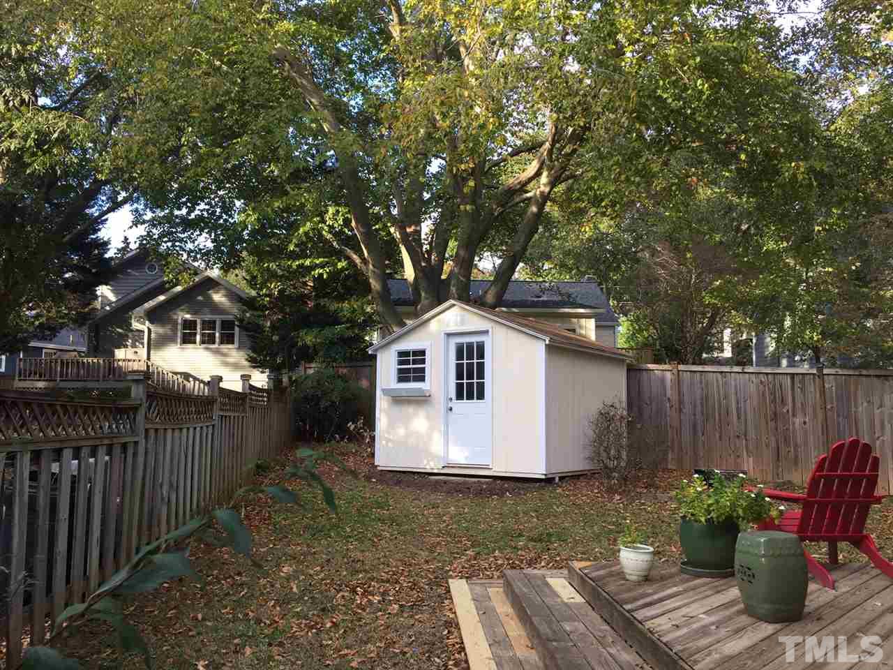1802 Reaves Drive Raleigh, NC 27608 - Photo 18 of 22 a view of backyard with wooden fence and large trees