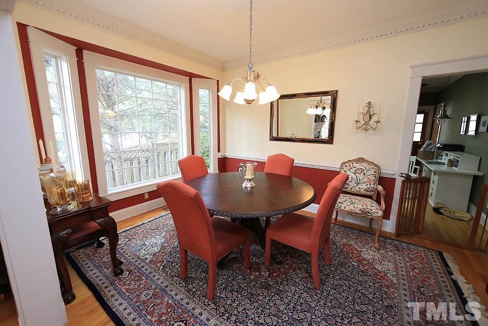1802 Reaves Drive Raleigh, NC 27608 - Photo 3 of 22 a view of a dining room with furniture window and wooden floor