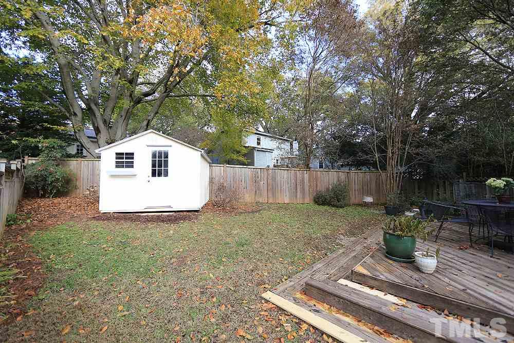 1802 Reaves Drive Raleigh, NC 27608 - Photo 22 of 22 a view of a backyard with table and chairs and wooden fence