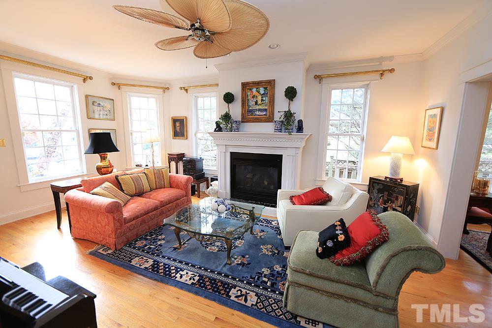 1802 Reaves Drive Raleigh, NC 27608 - Photo 6 of 22 a living room with furniture fireplace and a window