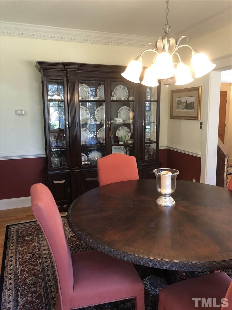 1802 Reaves Drive Raleigh, NC 27608 - Photo 7 of 22 a kitchen with a dining table chairs and chandelier