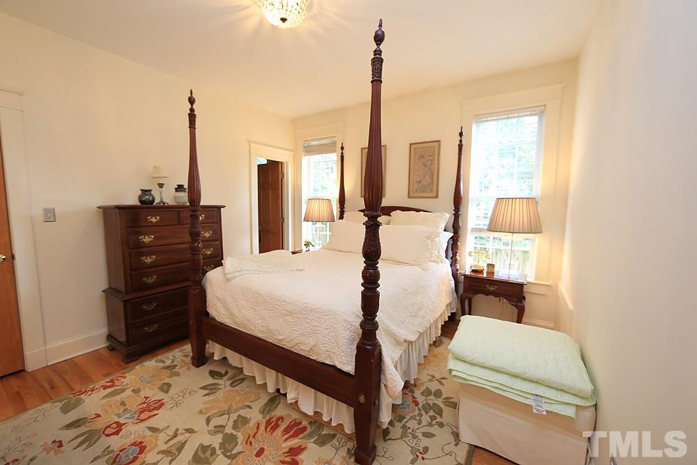 1802 Reaves Drive Raleigh, NC 27608 - Photo 10 of 22 a bed room with a bed and chair