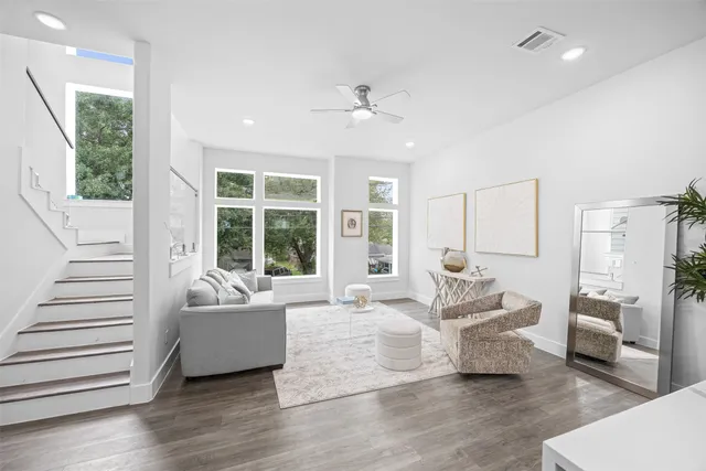 a living room with furniture and large windows