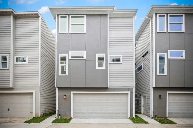 a front view of a house with garage