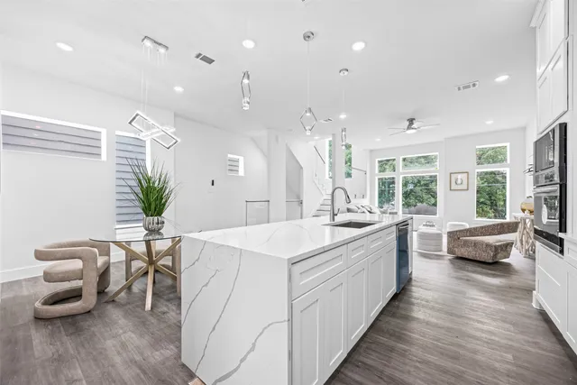a large white kitchen with a large window
