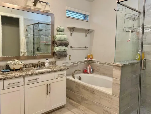 a bathroom with a granite countertop sink mirror and double