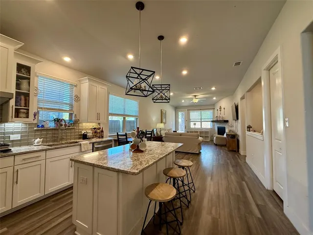 a large kitchen with a table and chairs