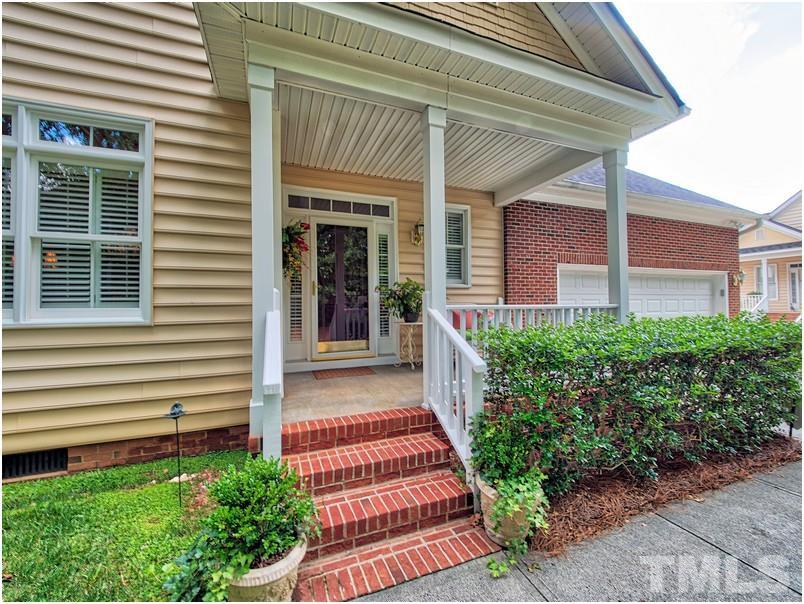 9012 Carrington Ridge Drive Raleigh, NC 27615 - Photo 1 of 22 a front view of a house with a garden