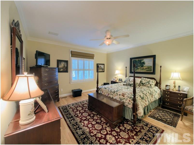 9012 Carrington Ridge Drive Raleigh, NC 27615 - Photo 12 of 22 a bed room with a bed and a lamp