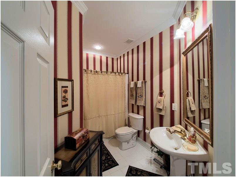 9012 Carrington Ridge Drive Raleigh, NC 27615 - Photo 17 of 22 a bathroom with a sink a toilet and shower