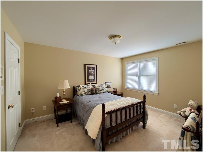 9012 Carrington Ridge Drive Raleigh, NC 27615 - Photo 19 of 22 a bedroom with a bed and a table in it