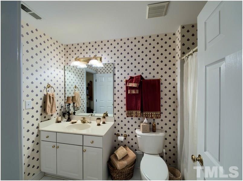 9012 Carrington Ridge Drive Raleigh, NC 27615 - Photo 22 of 22 a bathroom with a sink toilet and shower