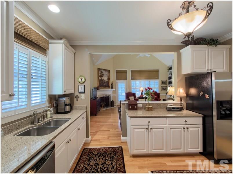 9012 Carrington Ridge Drive Raleigh, NC 27615 - Photo 7 of 22 a kitchen with a sink stove and refrigerator