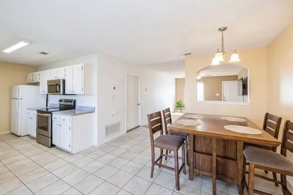 a dining room with furniture and window