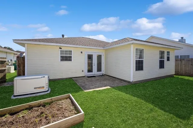 a view of an house with backyard space and garden