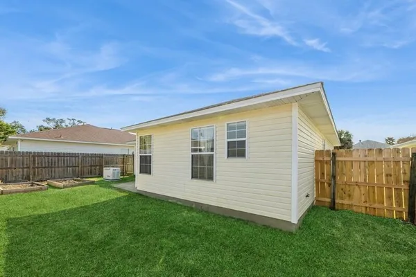 a view of a house with a backyard