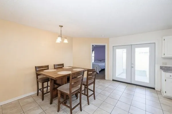 a view of a dining room with furniture and chandelier