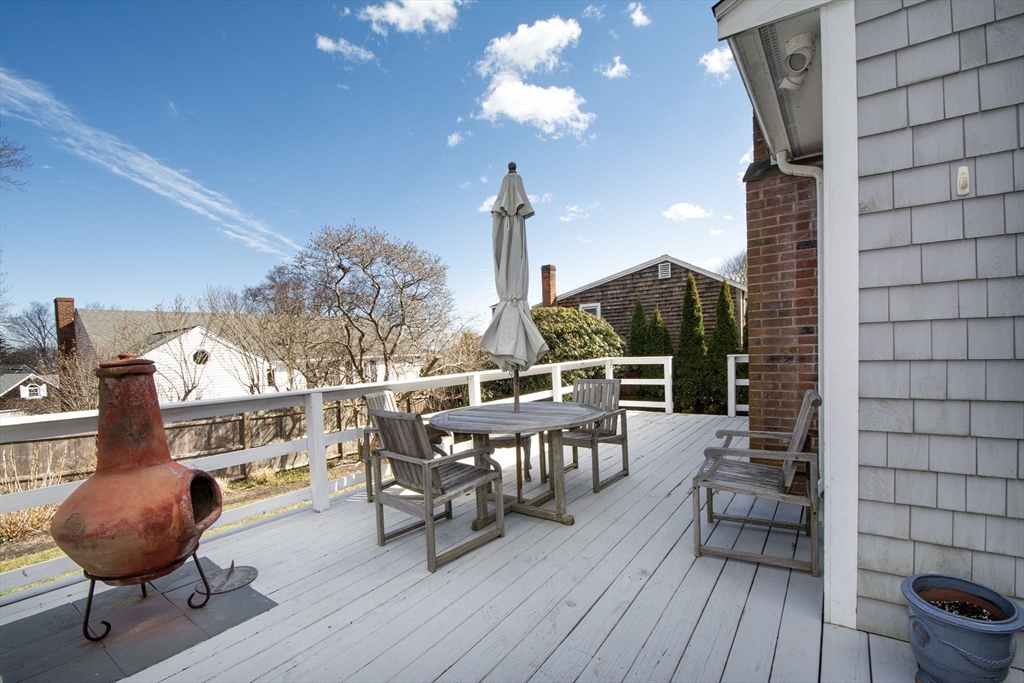 26 Bay Ridge Road Scituate, MA 02066 - Photo 6 of 11 a view of a roof deck with table and chairs and wooden floor