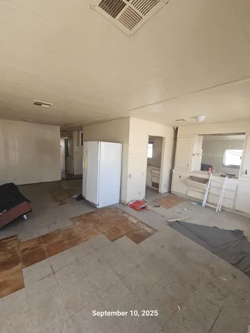 a view of a livingroom with wooden floor and white walls