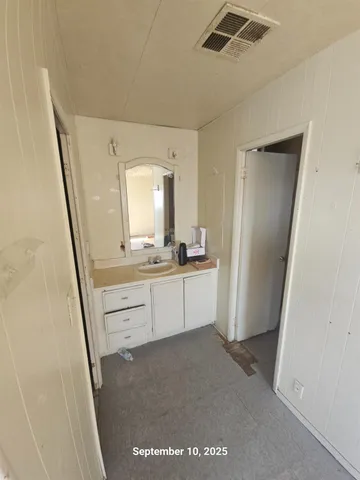 a bathroom with a sink a mirror and a vanity