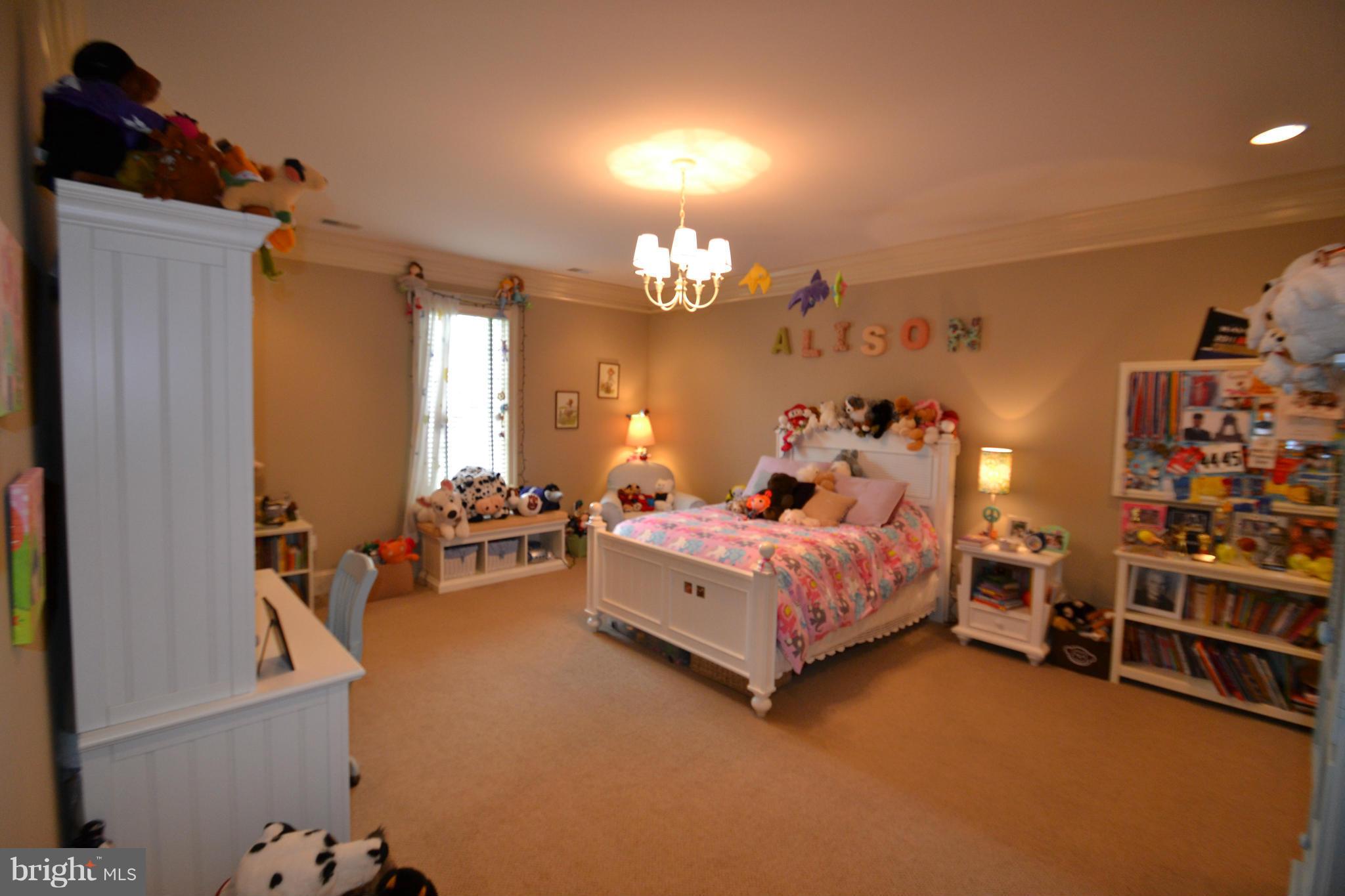 1827 Ridge Road Reisterstown, MD 21136 - Photo 18 of 30 a spacious bedroom with a bed and a chandelier