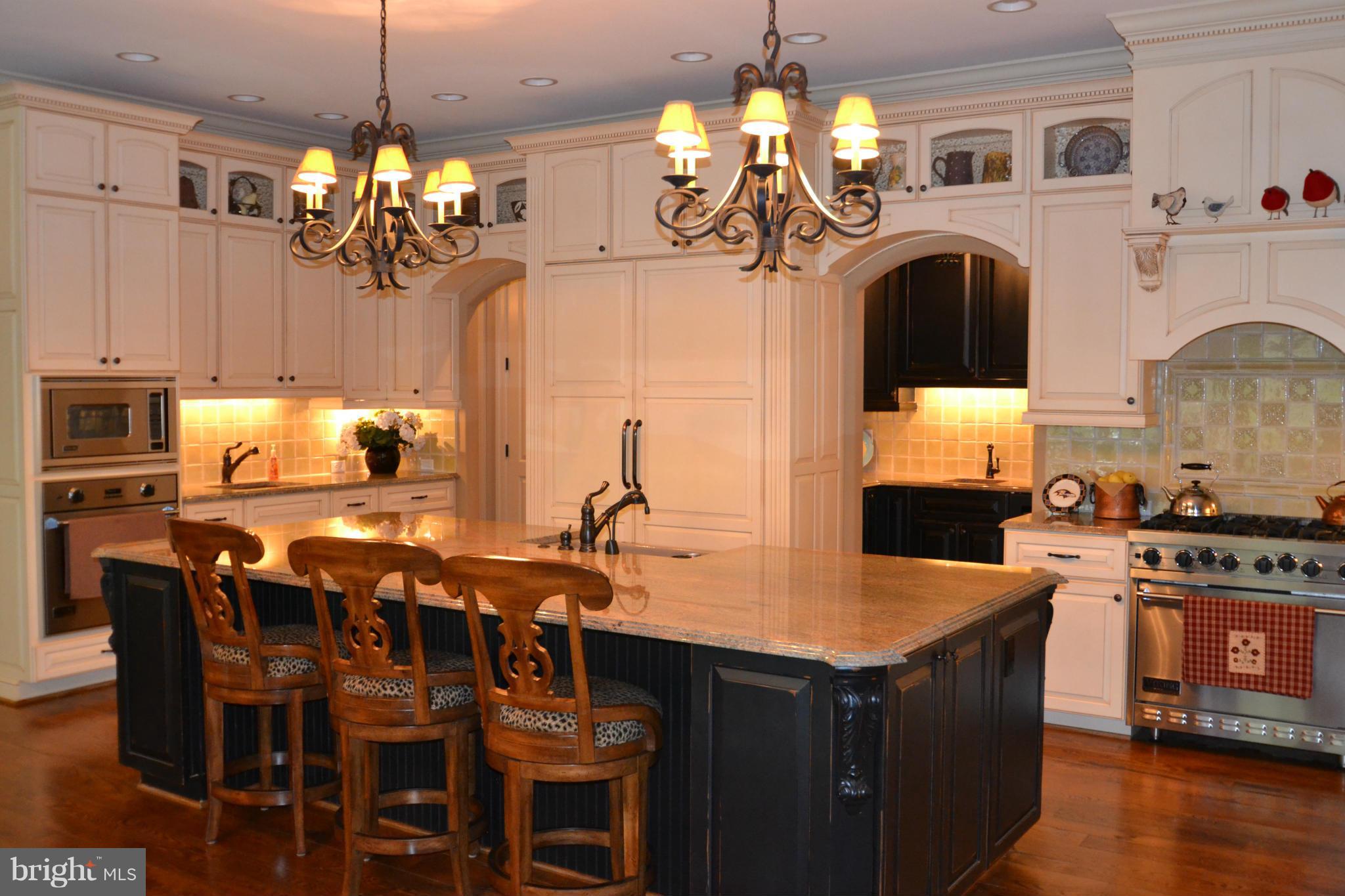 1827 Ridge Road Reisterstown, MD 21136 - Photo 10 of 30 a kitchen with kitchen island granite countertop a table chairs sink and stove top oven