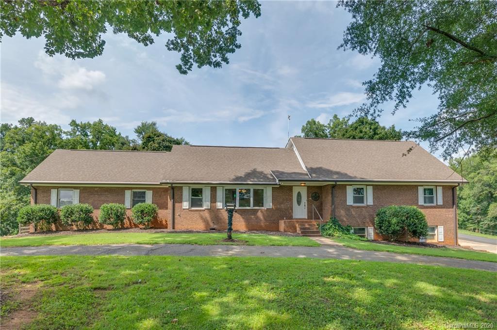 1914 Coxe Road Rutherfordton, NC 28139 - Photo 1 of 47 a front view of a house with a yard and potted plants