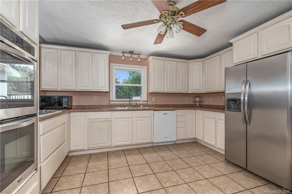 1914 Coxe Road Rutherfordton, NC 28139 - Photo 12 of 47 a kitchen with a refrigerator a sink and cabinets