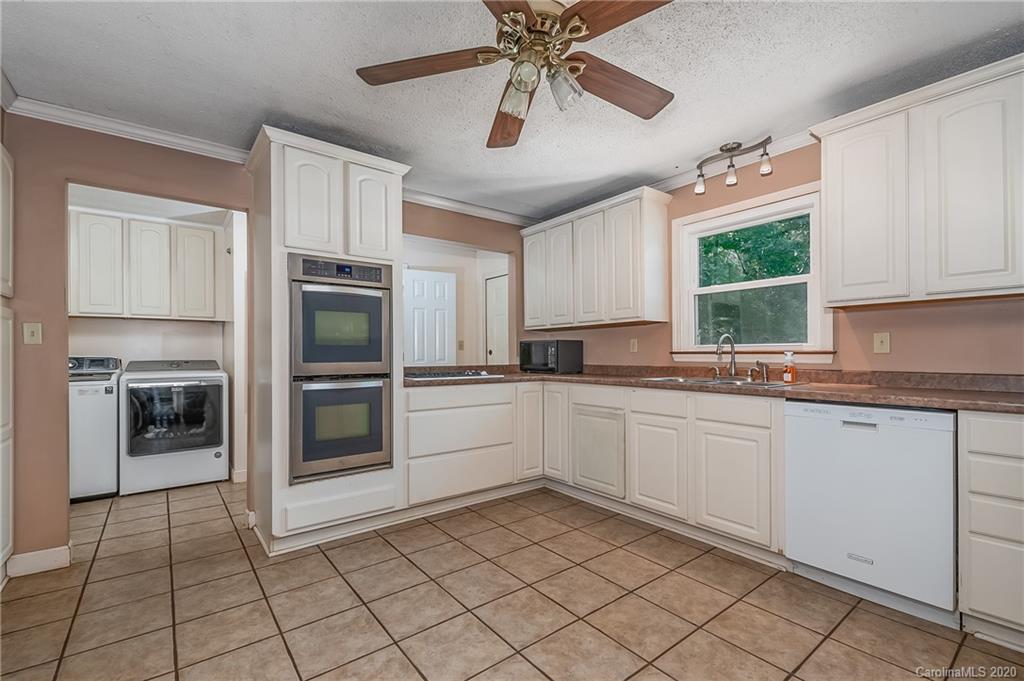 1914 Coxe Road Rutherfordton, NC 28139 - Photo 13 of 47 a kitchen with a stove a sink and a microwave
