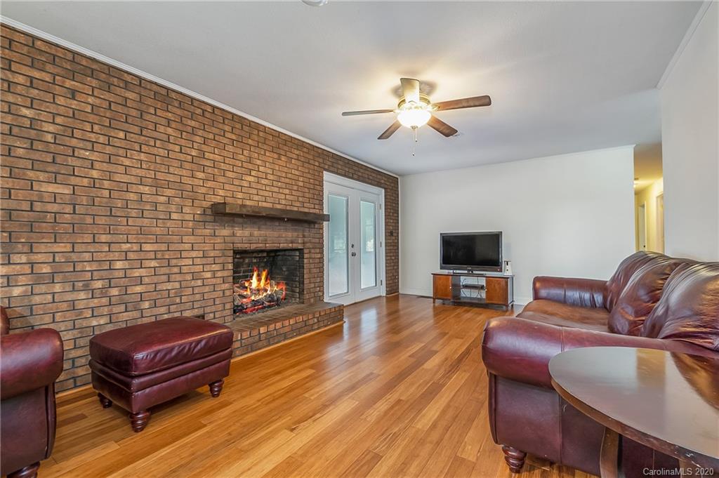 1914 Coxe Road Rutherfordton, NC 28139 - Photo 15 of 47 a living room with furniture a flat screen tv and a fireplace