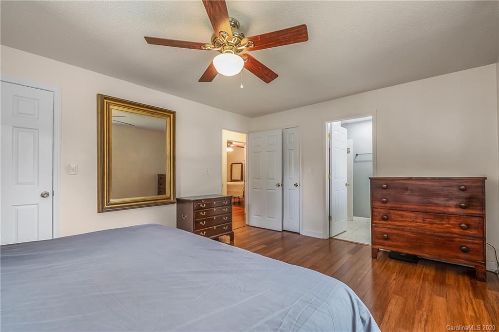 1914 Coxe Road Rutherfordton, NC 28139 - Photo 20 of 47 a bedroom with a bed and a chandelier