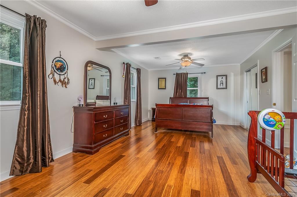 1914 Coxe Road Rutherfordton, NC 28139 - Photo 25 of 47 a bedroom with a bed and a dresser in it